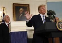 Trump signs $1.3 trillion spending bill with a warning