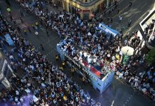 Manchester City celebrate Premier League title win with bus parade and manager Pep Guardiola throws a beer to fans
